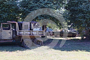 Old, broken military trucks were left unused in the outdoors.