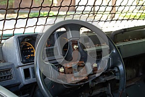 old broken military vehicle with bars on the front window, the car after the passage of hostilities