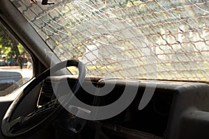 old broken military vehicle with bars on the front window, the car after the passage of hostilities