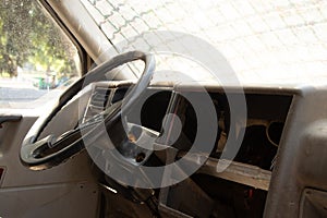 old broken military vehicle with bars on the front window, the car after the passage of hostilities