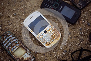 Old broken mobile phones found on the bottom of the sea