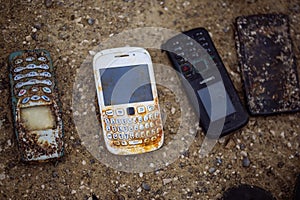 Old broken mobile phones found on the bottom of the sea