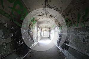 Old broken passage tunnel with light at the end, photographed with Wide-angle lens