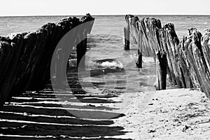 Old broken pier on the coast of the Baltic sea