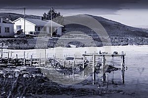 Old broken pier landscape blue sepia background