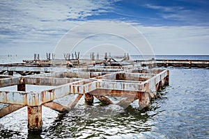 Old broken pier in the sea.