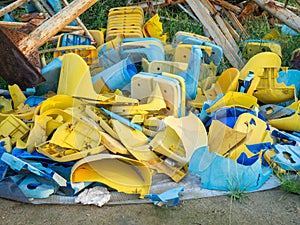 Old broken plastic chairs at the stadium. Fan riot concept. A pile of plastic chairs