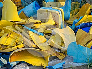 Old broken plastic chairs at the stadium. Fan riot concept. A pile of plastic chairs