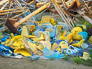 Old broken plastic chairs at the stadium. Fan riot concept. A pile of plastic chairs. Broken and abandoned