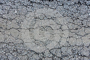 old broken road with cracked asphalt .