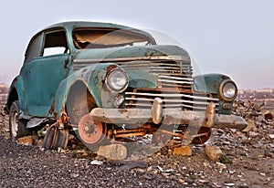 Old broken rusty abandoned car