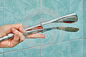 An old broken shower head needs replacement