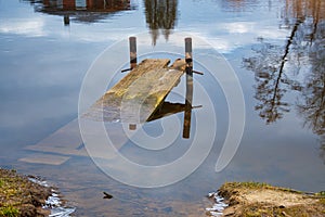 Old broken sunken jetty in a tranquil lake