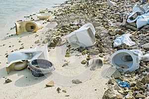 Old broken toilets on the tropical beach