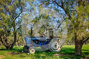 Old broken tractor abandoned in the forest
