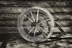 Old broken wagon wheel at the wall