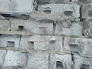 Old broken wall of gray silicate brick