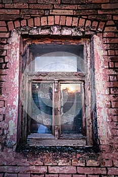 Old broken window on an abandoned old building.