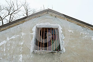 Old broken window on ruin house.