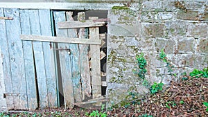 Old broken wooden farm door
