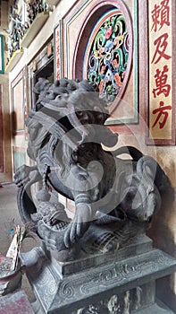 Old Bronz lion the guardian of a Chinese shrine in Tarad Noi community on Chaopraya River side in Bangkok photo