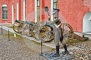 The old bronze cannons in the inner yard of the St. Peter and Paul fortress and the gunner mannequin.