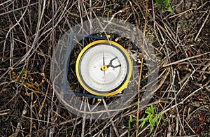 Old bronze compass on natural texured background.