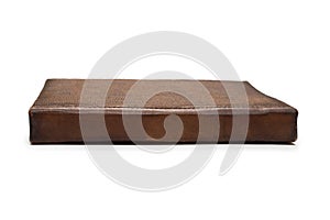 An old brown book isolated on white background