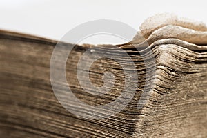 An old brown book with a white background.