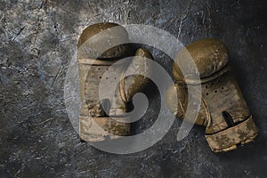 Old brown Boxing gloves on a concrete background