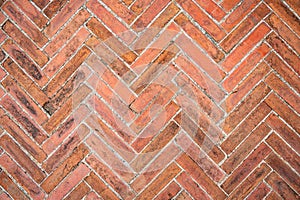 Old brown bricks tiled floor with zigzag pattern texture for background