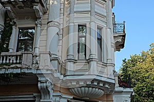 Old brown concrete wall of a historic building with white columns