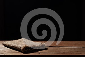 Old brown dark wood texture and cloth bag with dark background f