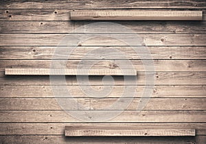 Old brown empty shelf on wooden wall