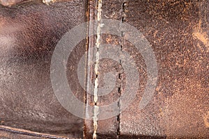 Old brown leather with a sewn seam