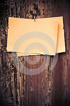 Old brown paper on wood board background