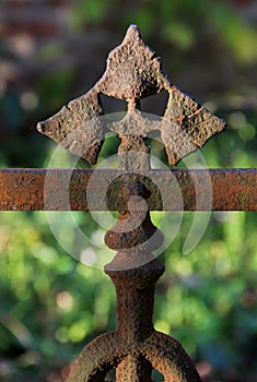 Old brown rusty weathered fence ornament close up.