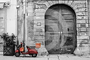 Old Brown Vespa against Old buildings