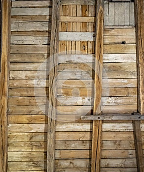 Old brown wall made of planks and thick wooden beams