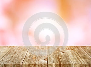 Old brown wooden plank with blurred pink flower nature backgrounds