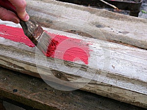 Old brushes in the paint process of painting an old board