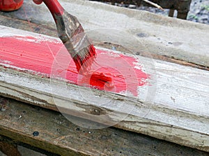 Old brushes in the paint process of painting an old board