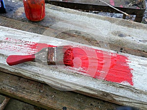 Old brushes in the paint process of painting an old board