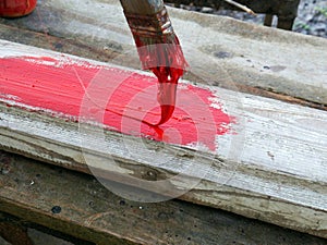 Old brushes in the paint process of painting an old board