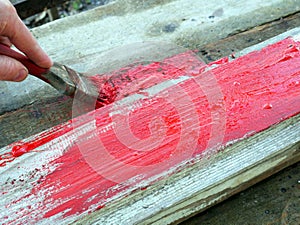 Old brushes in the paint process of painting an old board