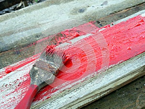 Old brushes in the paint process of painting an old board