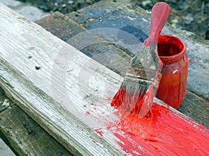 Old brushes in the paint process of painting an old board