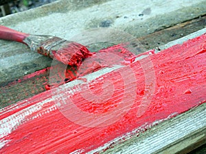 Old brushes in the paint process of painting an old board