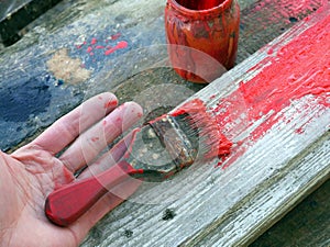 Old brushes in the paint process of painting an old board