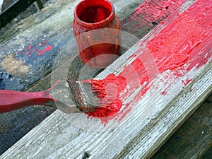 Old brushes in the paint process of painting an old board